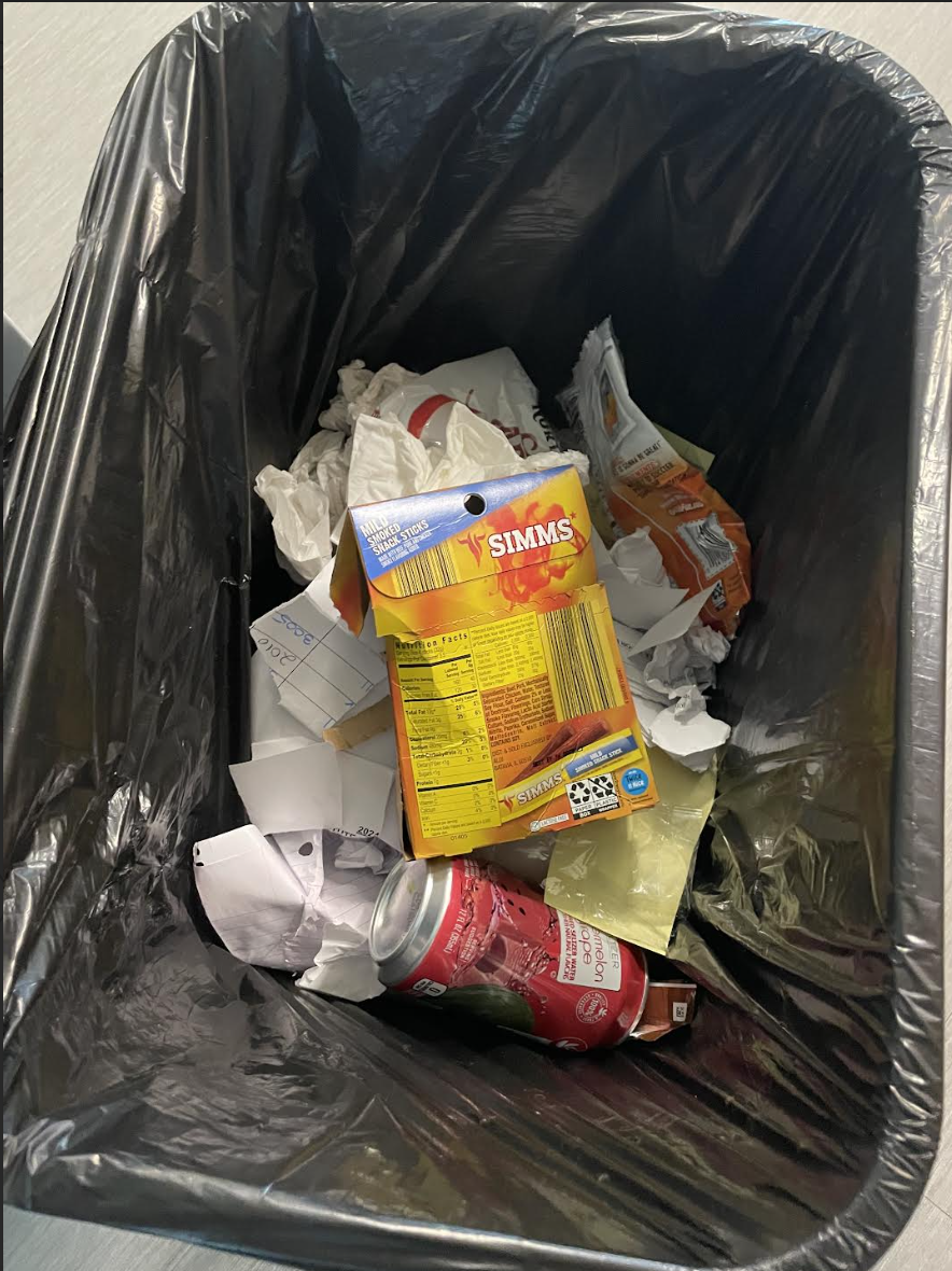 A trashcan from a classroom shows that some students, in response to the "no food" rule, are sneaking snacks.